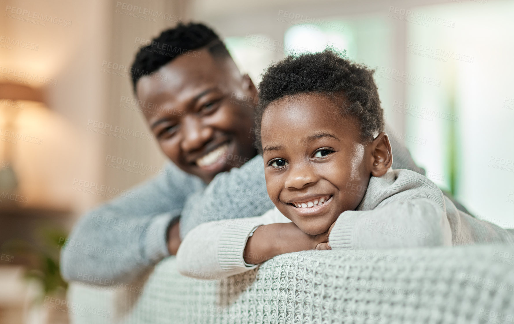 Buy stock photo Cropped portrait of an adorable little boy and his father relaxing on a sofa in their living room at home