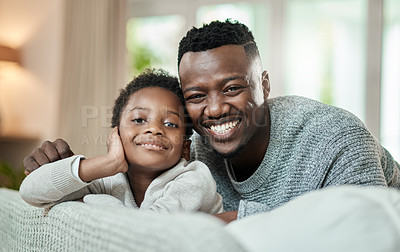 Buy stock photo Cropped portrait of an adorable little boy and his father relaxing on a sofa in their living room at home