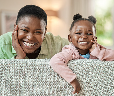 Buy stock photo Cropped portrait of an adorable little girl and her mother relaxing on a sofa in their living room at home