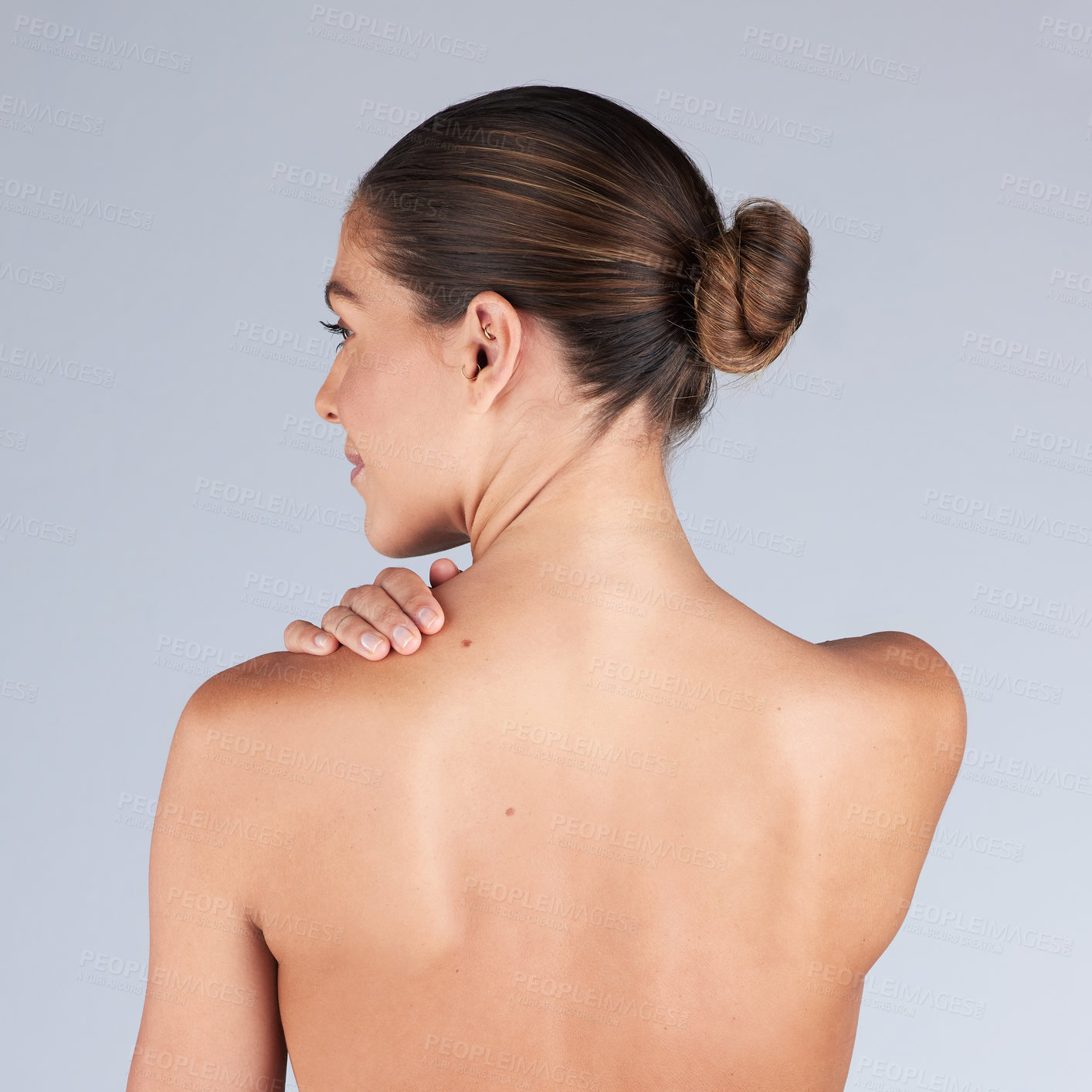 Buy stock photo Shot of a young woman standing alone in the studio and posing