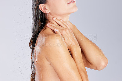 Buy stock photo Studio shot of an unrecognisable woman taking a shower against a grey background