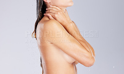 Buy stock photo Studio shot of an unrecognisable woman taking a shower against a grey background