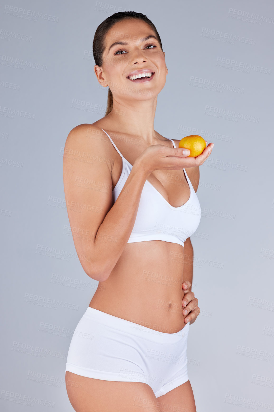 Buy stock photo Portrait, woman and orange smiling for healthy diet, fitness and nutrition in grey studio background. Wellness, female person and fruit happy for organic meal, snack or vegan eating with vitamins