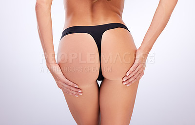 Buy stock photo Studio shot of an unrecognizable woman posing in her underwear against a grey background