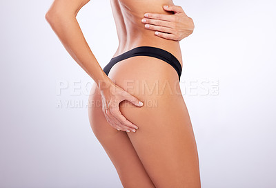 Buy stock photo Studio shot of an unrecognizable woman posing in her underwear against a grey background