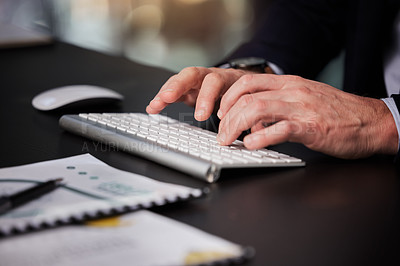 Buy stock photo Cropped shot of an unrecognisable businessman typing on his keyboard