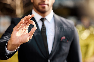 Buy stock photo Shot of a businessman holding a pill