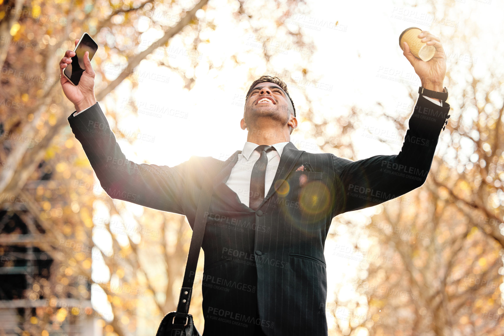 Buy stock photo Shot of a young businessman cheering in excitement