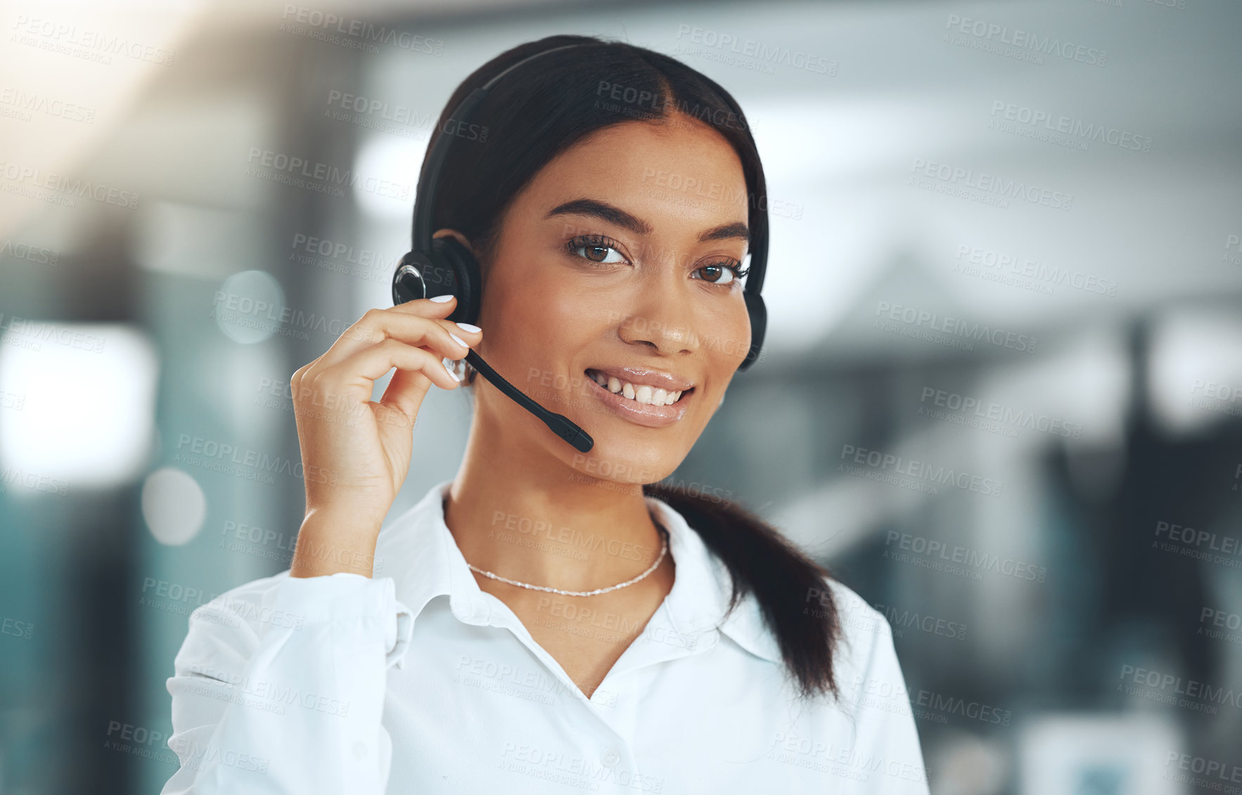 Buy stock photo Shot of a young call centre agent standing alone in her office