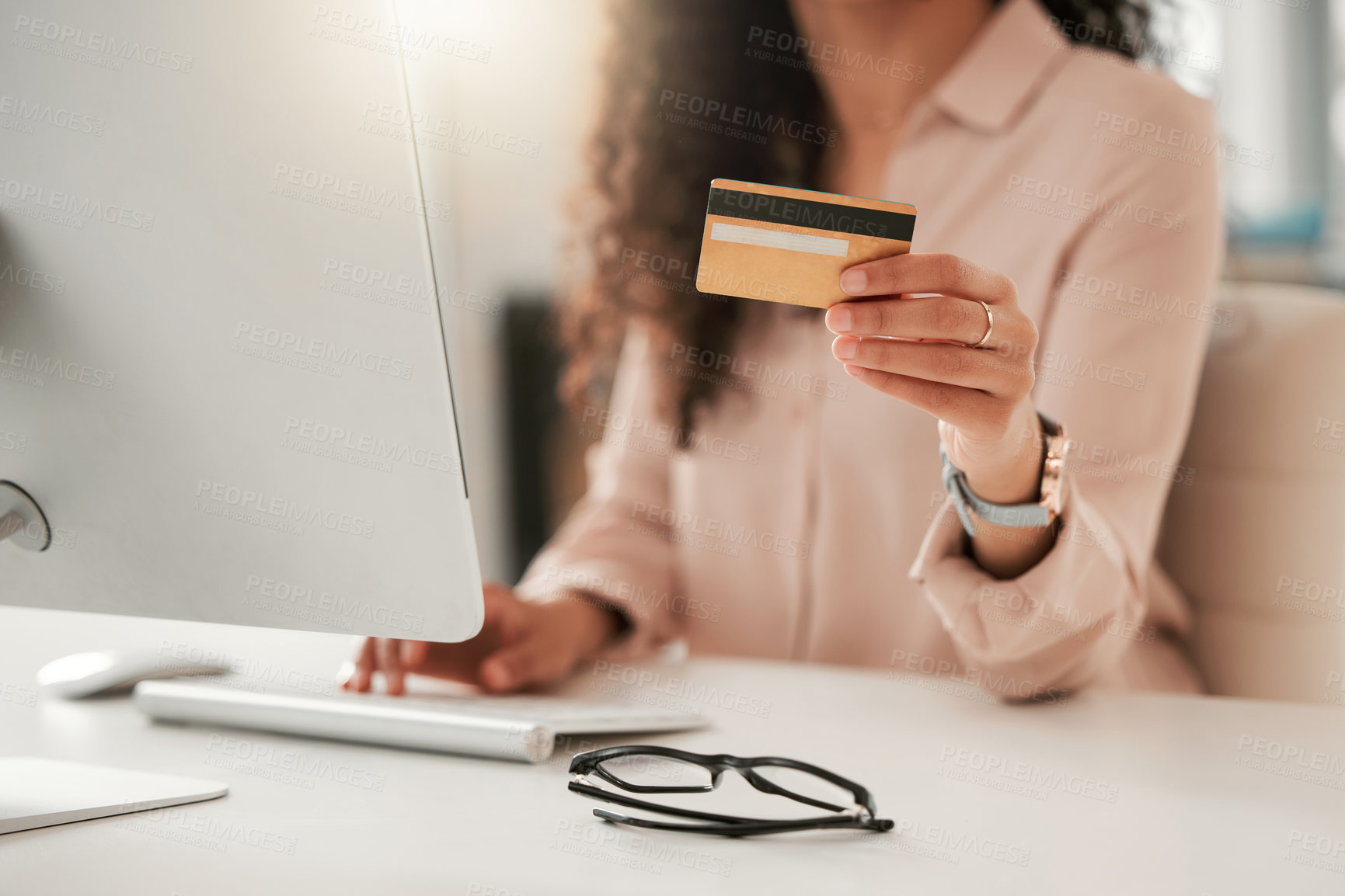 Buy stock photo Cropped shot of an unrecognizable call center agent using a credit card at work