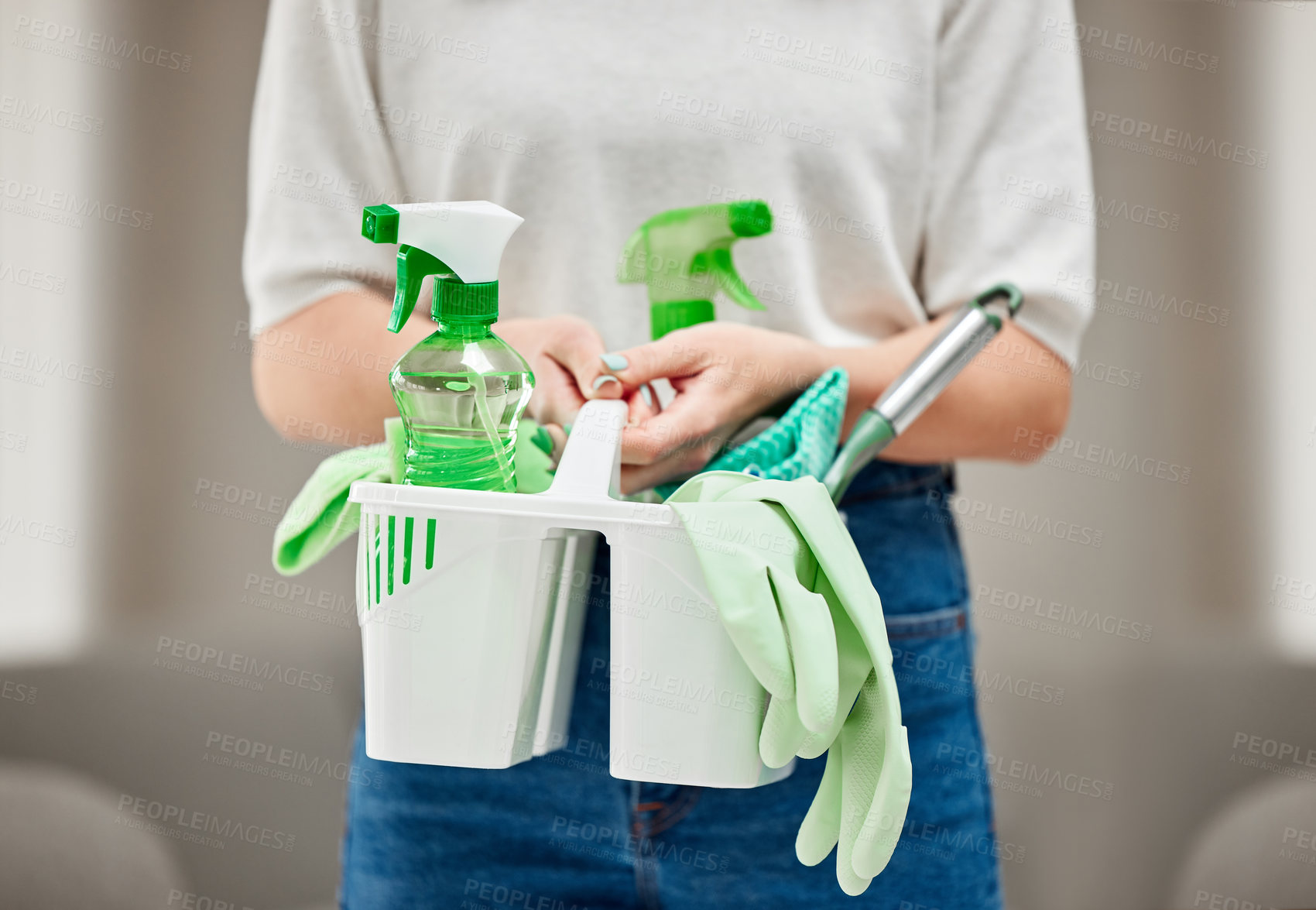 Buy stock photo Shot of an unrecognizable person holding cleaning supplies at home
