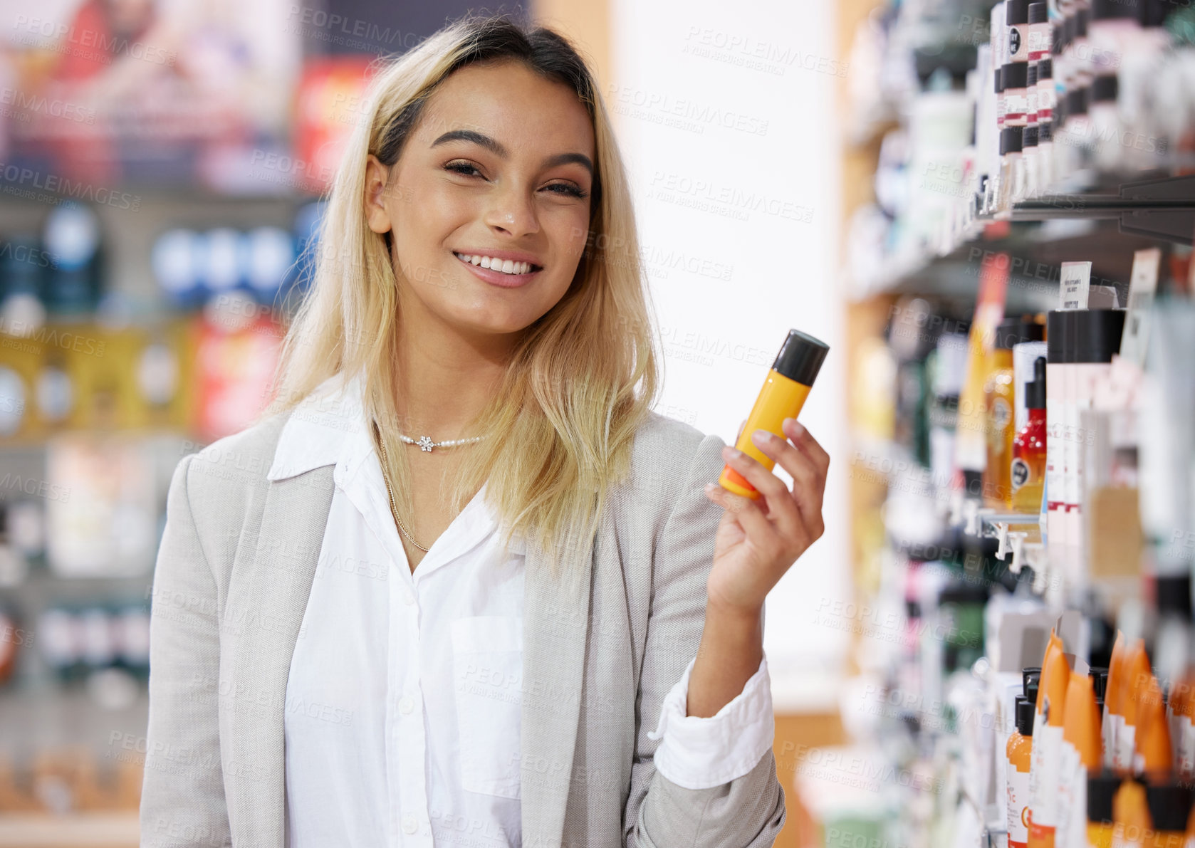 Buy stock photo Cropped portrait of an attractive young woman shopping in a cosmetics store
