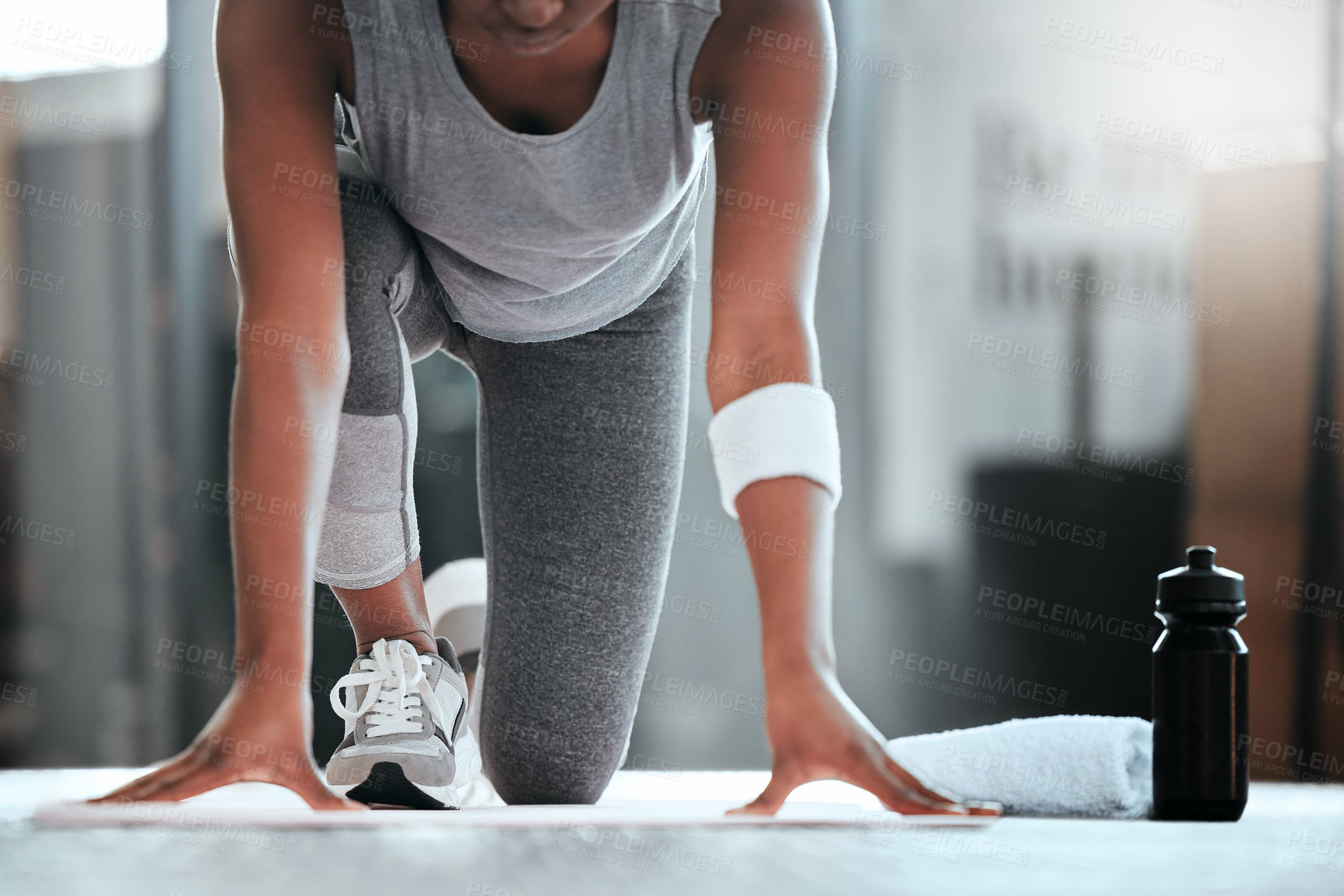 Buy stock photo Cropped shot of an unrecognizable woman getting into position for pushups at the gym