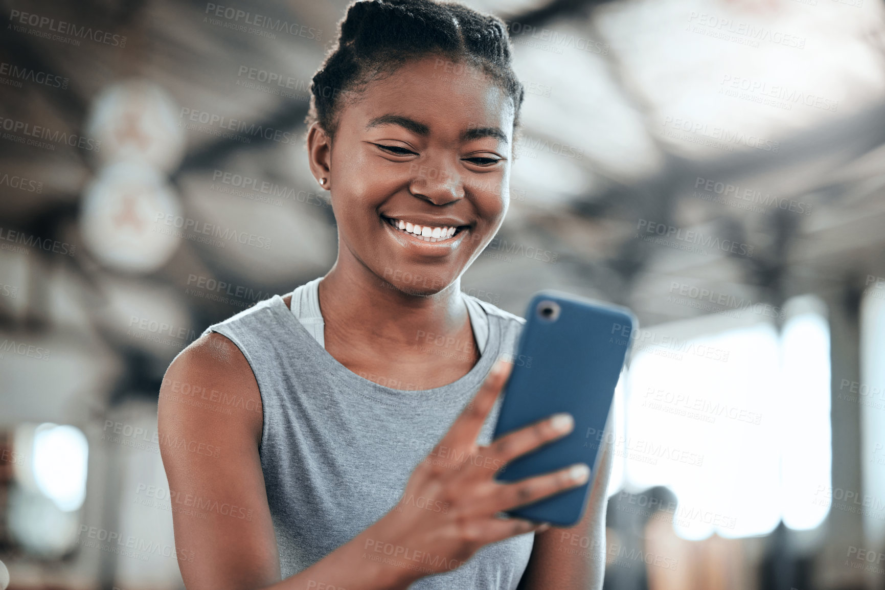 Buy stock photo Social media, happy or black woman with phone in gym to search for a sports blog in training or exercise. Fitness app, smile or healthy girl athlete relaxing or reading online mobile content on break