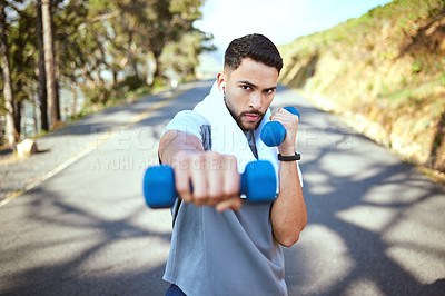 Buy stock photo Man, dumbbell and punch in nature fitness for exercise, workout or training in the outdoors. Portrait of fit, active and sporty male person punching with weights in healthy outdoor cardio endurance