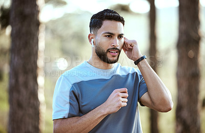 Buy stock photo Fitness, man and outdoor with earphones for music on run or workout for motivation. Male athlete person or runner listening to audio in nature forest for training exercise, running and wellness goals