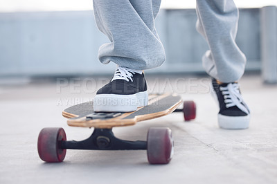 Buy stock photo Feet, legs and sneakers outdoor on skateboard for balance with streetwear, style inspiration and concrete floor. Shoes of person, fashion and longboard for eco friendly transport, hobby and exercise