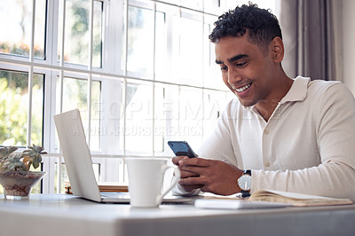 Buy stock photo Shot of a young male using his cellphone at home