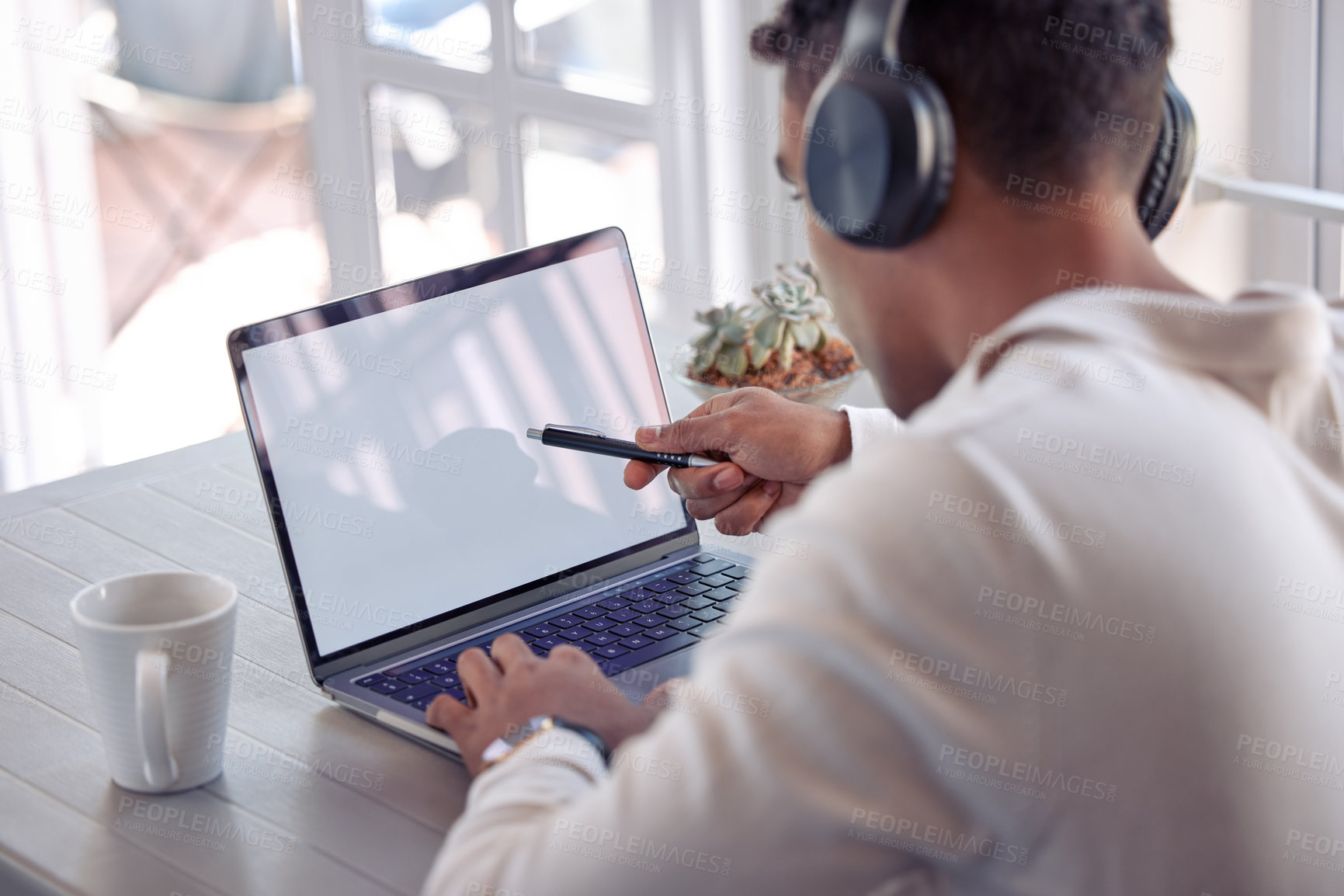 Buy stock photo Shot of a young male using his laptop at home