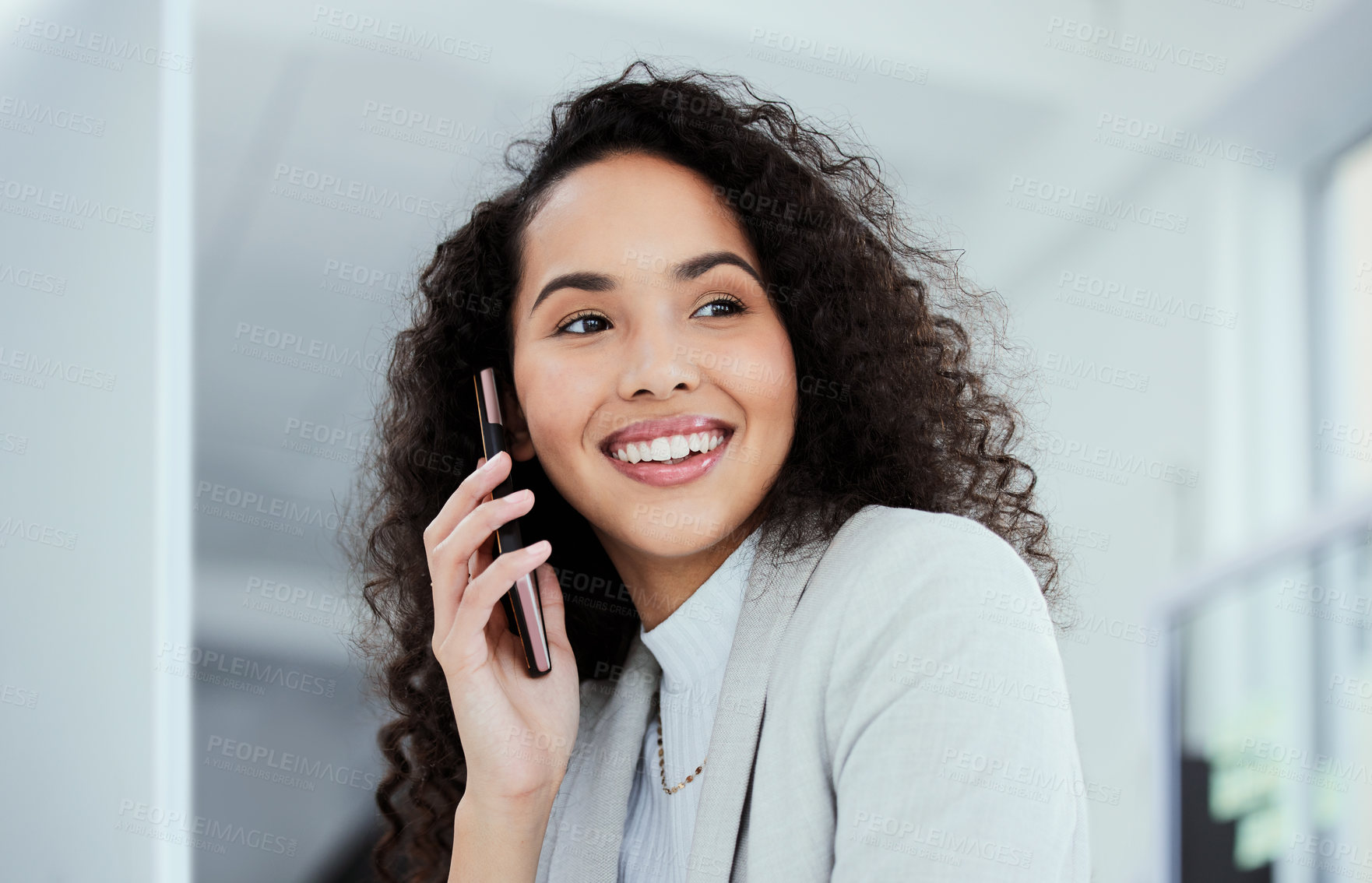 Buy stock photo Shot of a young businesswoman using her smartphone to make a phone call