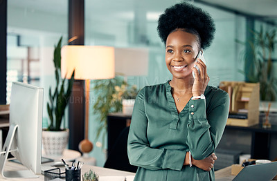 Buy stock photo Shot of a young businesswoman talking on a cellphone in an office