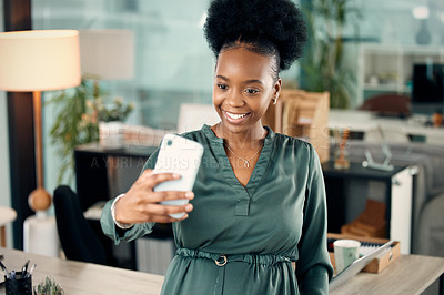 Buy stock photo Shot of a young businesswoman taking selfies in an office