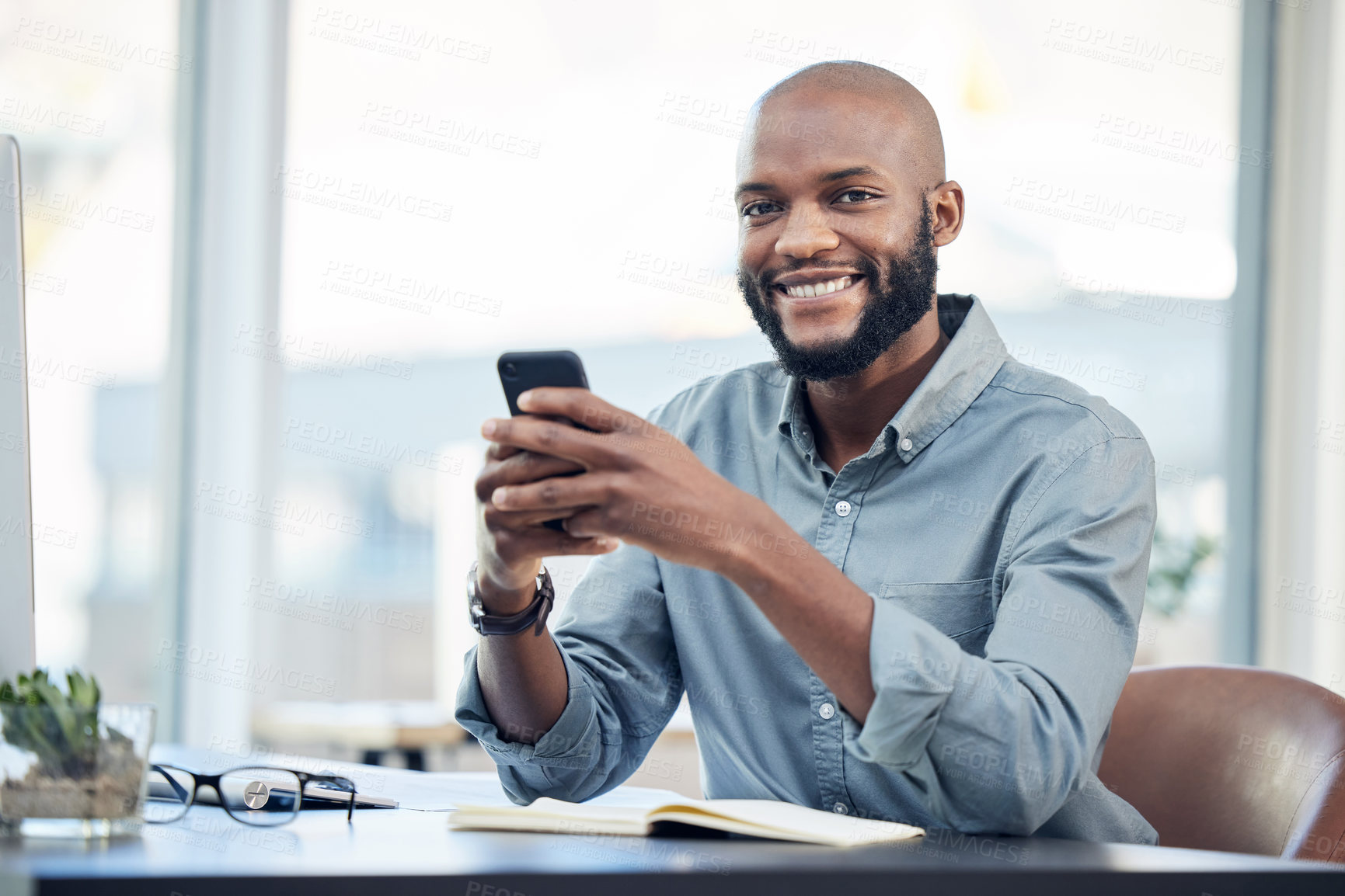 Buy stock photo Black man in office, portrait and social media on smartphone with smile, lunch break and communication. Male employee at workplace, using phone and technology, mobile app and contact with chat 