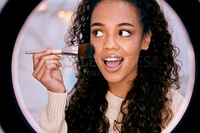 Buy stock photo Shot of a young woman doing her makeup while recording a video for her blog
