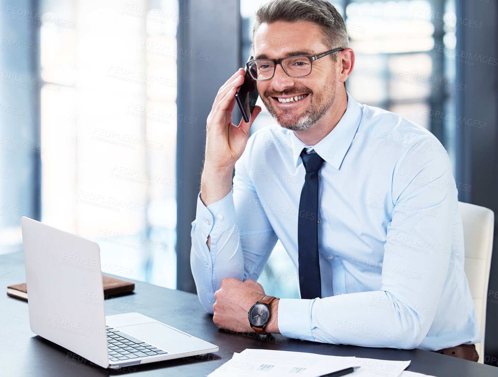 Buy stock photo Shot of a mature businessman on a call in an office at work