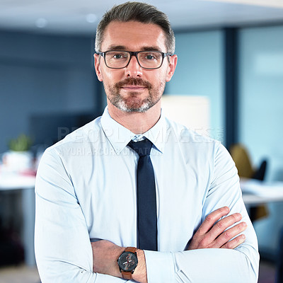 Buy stock photo Shot of a mature businessman standing with his arms crossed crossed in an office at work