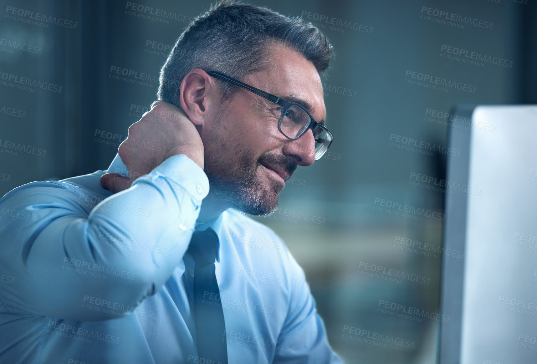 Buy stock photo Shot of a businessman suffering with neck pain while working at his desk