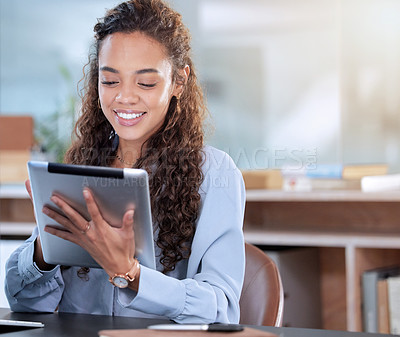 Buy stock photo Cropped shot of an attractive young businesswoman working on her tablet while sitting in the office