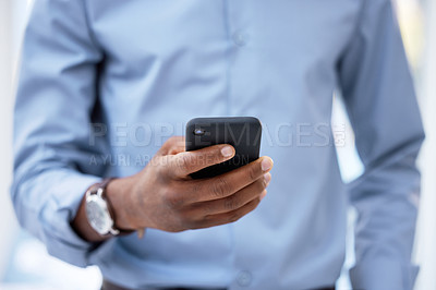 Buy stock photo Cropped shot of a businessman using his cellphone