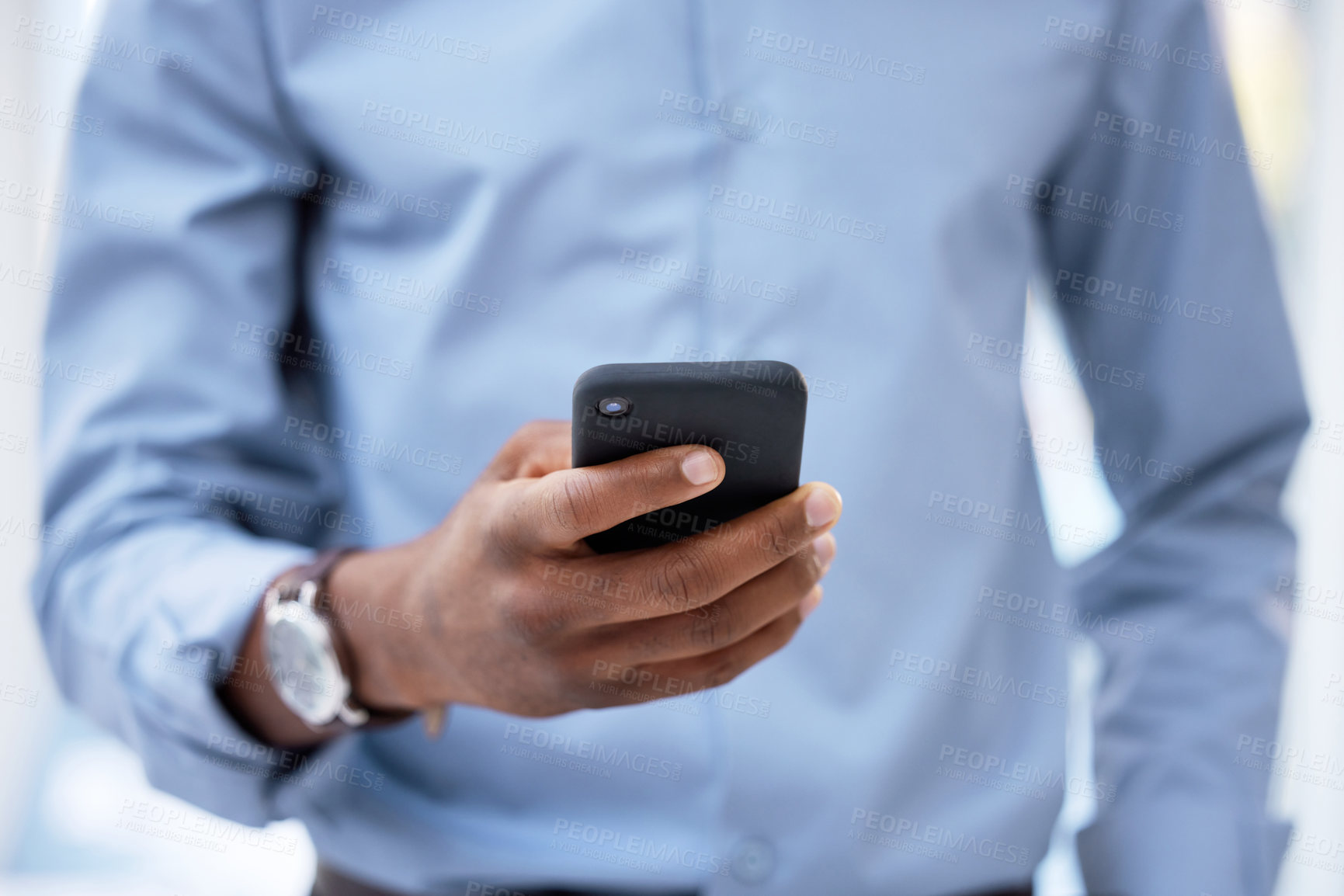 Buy stock photo Cropped shot of a businessman using his cellphone