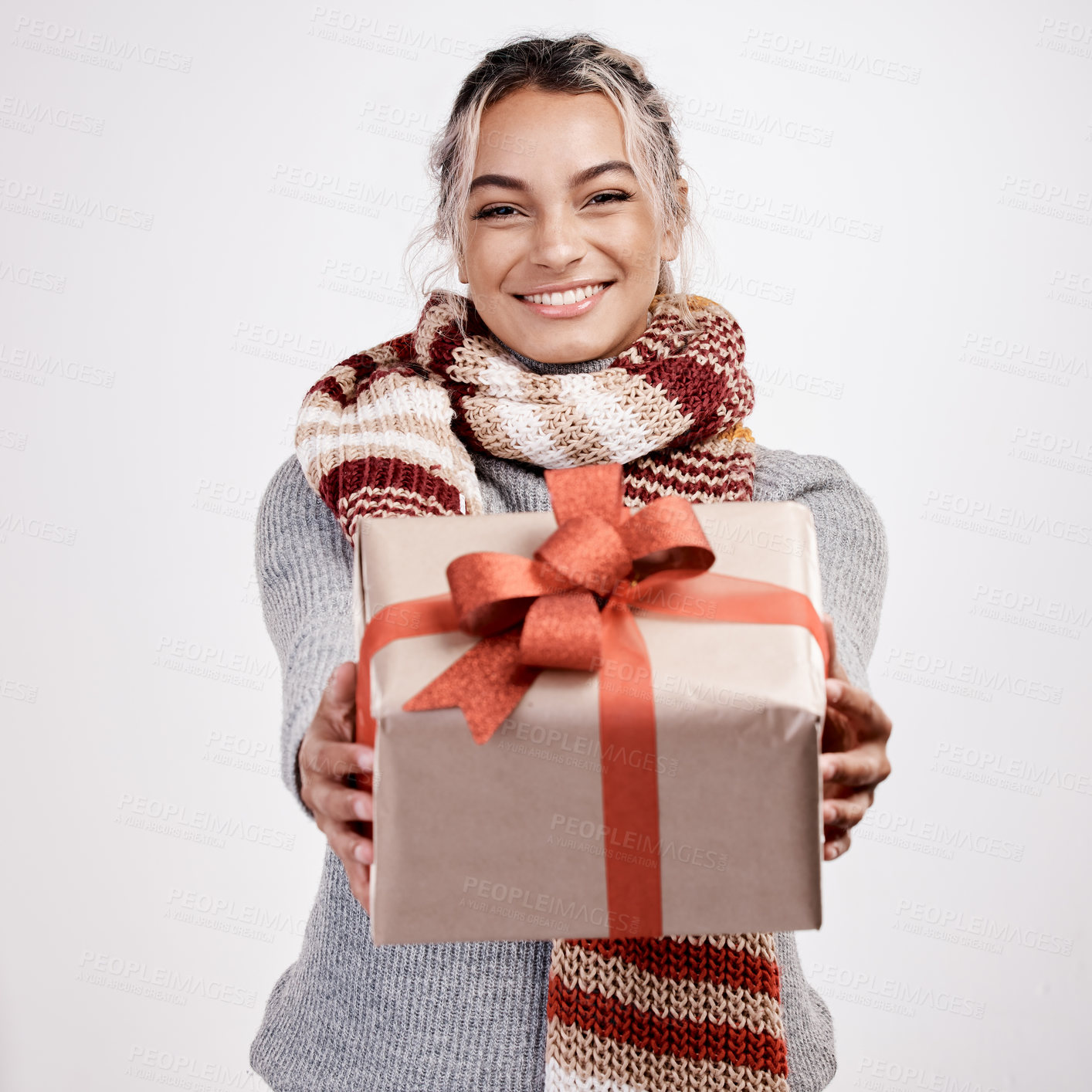 Buy stock photo Christmas, woman and gift with smile in portrait for festive, winter and holiday on studio backdrop. Female person, cheerful and happy in celebration with present for season with decor for home