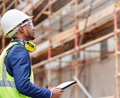 Buy stock photo Shot of a young man working on a construction site outside