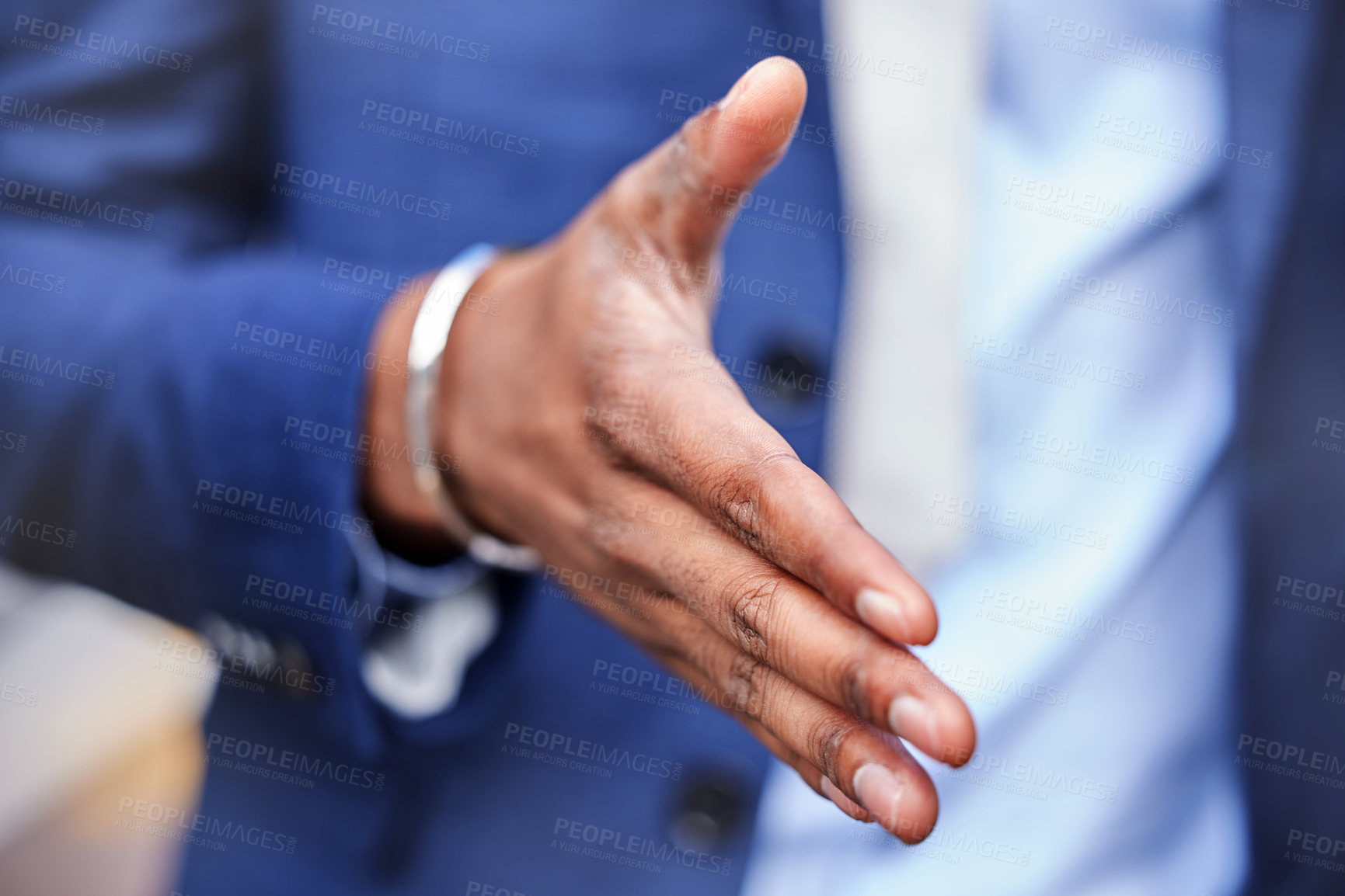 Buy stock photo Shot of an unrecognizable businessman making a handshaking gesture outside