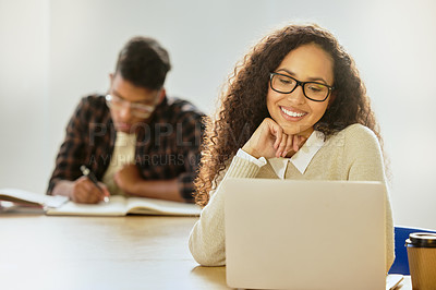 Buy stock photo Cropped shot of an attractive young female college student working on her laptop while sitting in class