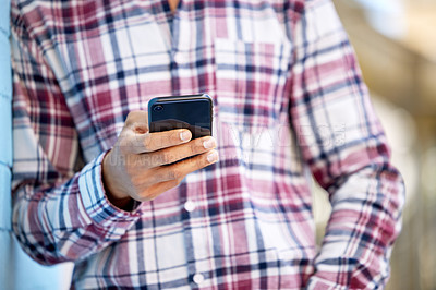Buy stock photo Closeup shot of an unrecognisable student using a cellphone on campus