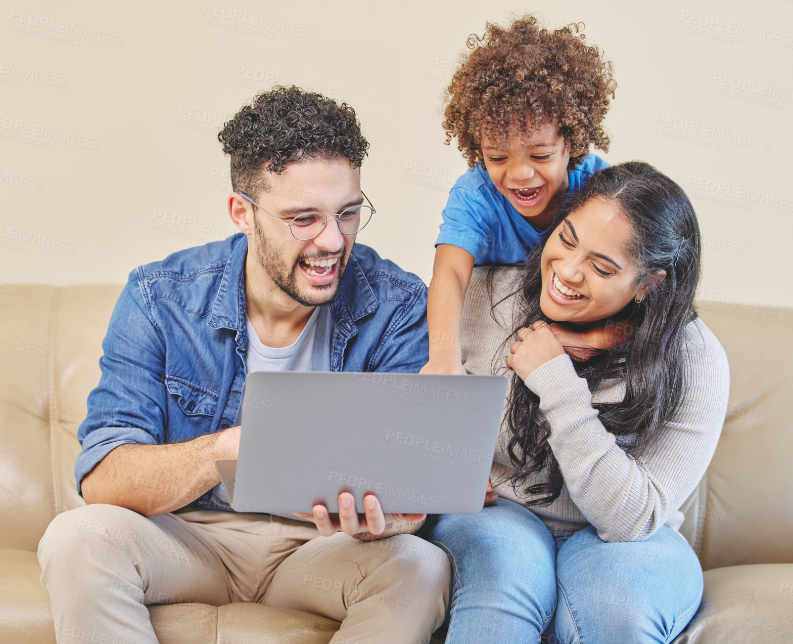 Buy stock photo Shot of a young family using a laptop together