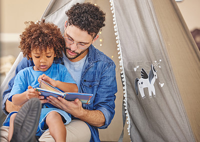 Buy stock photo Shot of a father reading to his son