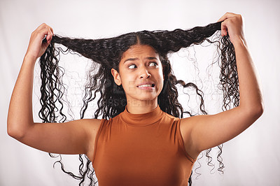 Buy stock photo Stress, woman and hair damage with worry from messy hairstyle and problem in a studio. Anxiety, texture issue and hairdresser fail with color treatment and bad haircut results with grey background 