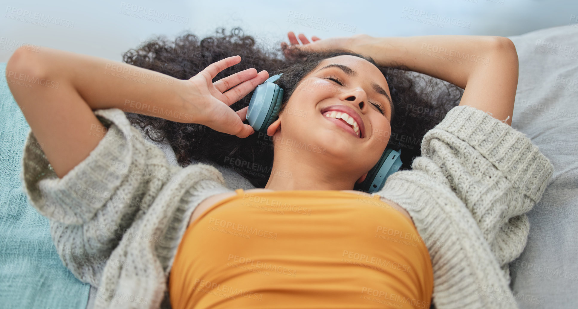 Buy stock photo Happy, music and woman with headphones on sofa for streaming subscription, playlist and radio. Relax, home and person laying on couch listening to audio, song and track in living room on weekend