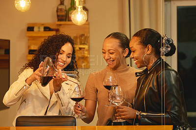 Buy stock photo Shot of a group of young women enjoying some wine
