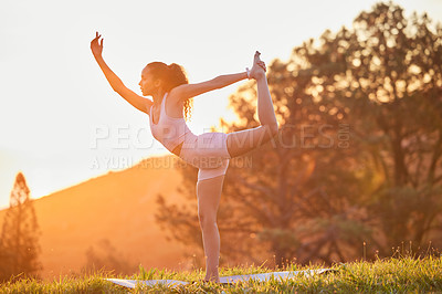 Buy stock photo Full length shot of an attractive young woman practicing yoga outside on a sunny morning