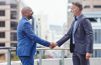 Buy stock photo Cropped shot of two  businessmen shaking hands outside