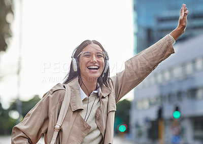 Buy stock photo Shot of a young businesswoman hailing a cab in town