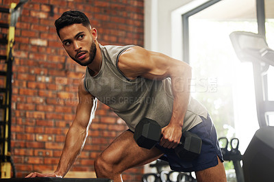 Buy stock photo Exercise, fitness and man with dumbbell in gym for weightlifting, bodybuilder training and workout. Sports, strong muscles and serious male person lift weight for wellness, healthy body and strength