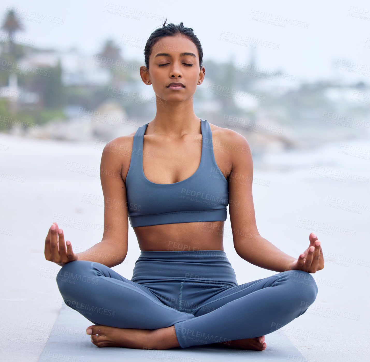 Buy stock photo Yoga, lotus meditation and woman at beach for mindfulness, peace and calm at sea to relax. Zen, ocean and padmasana pose for exercise, fitness and wellness for body of healthy Indian girl outdoor