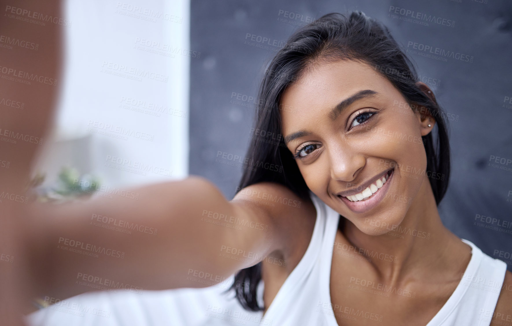 Buy stock photo Shot of a beautiful young woman taking a selfie at home